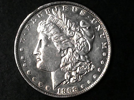Silver Morgan Dollar coin with a portrait and '1898' on a black background