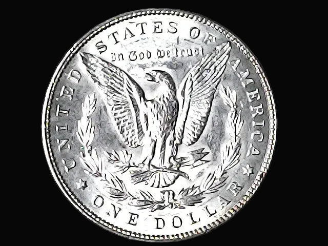 Silver Dollar with an eagle design and 'In God We Trust' inscription on a black background