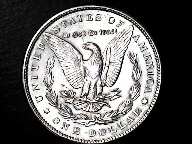 Silver Dollar with an eagle design on a black background 