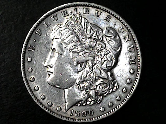Silver Morgan Dollar with 'E Pluribus Unum', 'Liberty'  and '1890' inscriptions on a black background with case