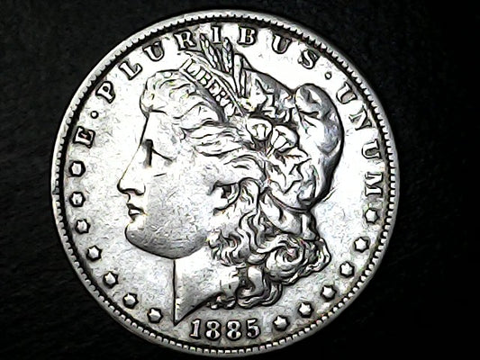 Silver Morgan dollar coin from 1885 with detailed design on a black background