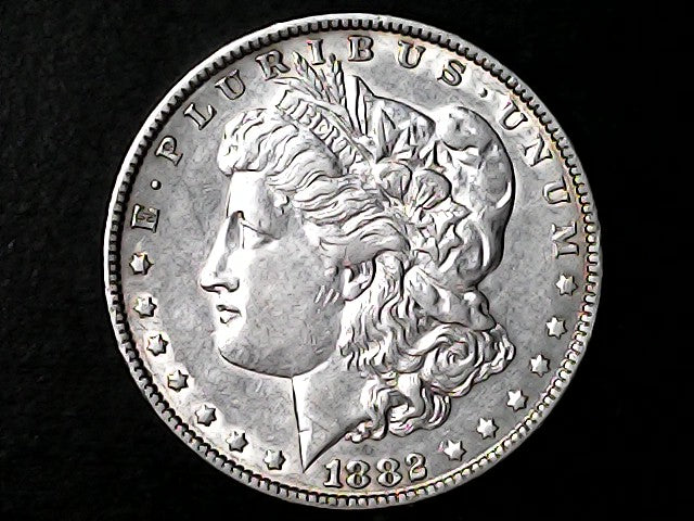 Silver Morgan Dollar Left-facing profile of Liberty wearing a Phrygian cap, with 'LIBERTY', "E PLURIBUS UNUM" and '1882' inscriptions on a black background with case