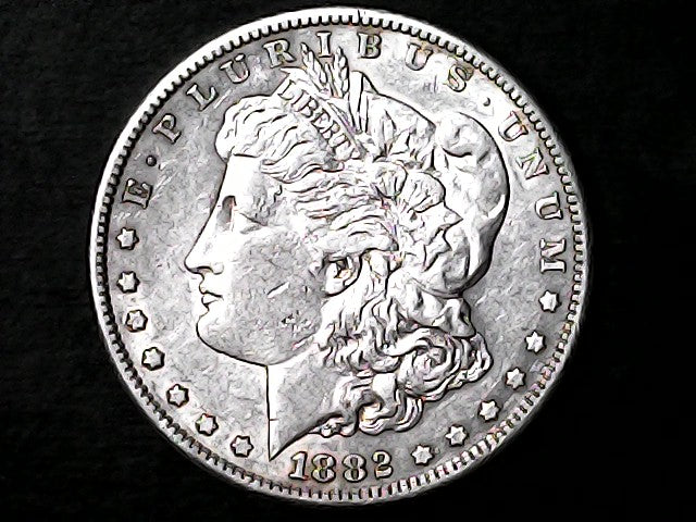 Silver Morgan Dollar Left-facing profile of Liberty wearing a Phrygian cap, with 'LIBERTY', "E PLURIBUS UNUM" and '1882' inscriptions on a black background with case