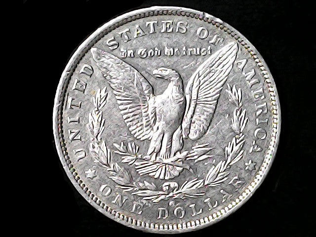 Silver Dollar with an eagle design, 'In God We Trust' and 'O' inscriptions on a black background 