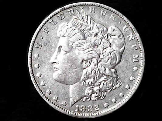 Silver Morgan Dollar Left-facing profile of Liberty wearing a Phrygian cap, with 'LIBERTY', "E PLURIBUS UNUM" and '1882' inscriptions on a black background with case
