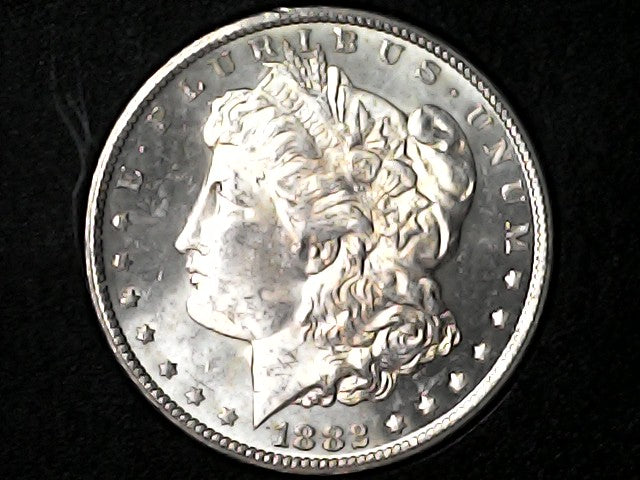 Silver Morgan Dollar Left-facing profile of Liberty wearing a Phrygian cap, with 'LIBERTY', "E PLURIBUS UNUM" and '1882' inscriptions on a black background with case