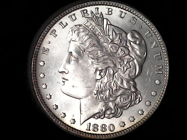 Silver Morgan Dollar Left-facing profile of Liberty wearing a Phrygian cap, with 'LIBERTY', "E PLURIBUS UNUM" and '1880' inscriptions on a black background with case