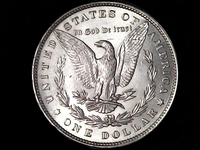 Silver Dollar with an eagle design and 'In God We Trust' inscription on a black background