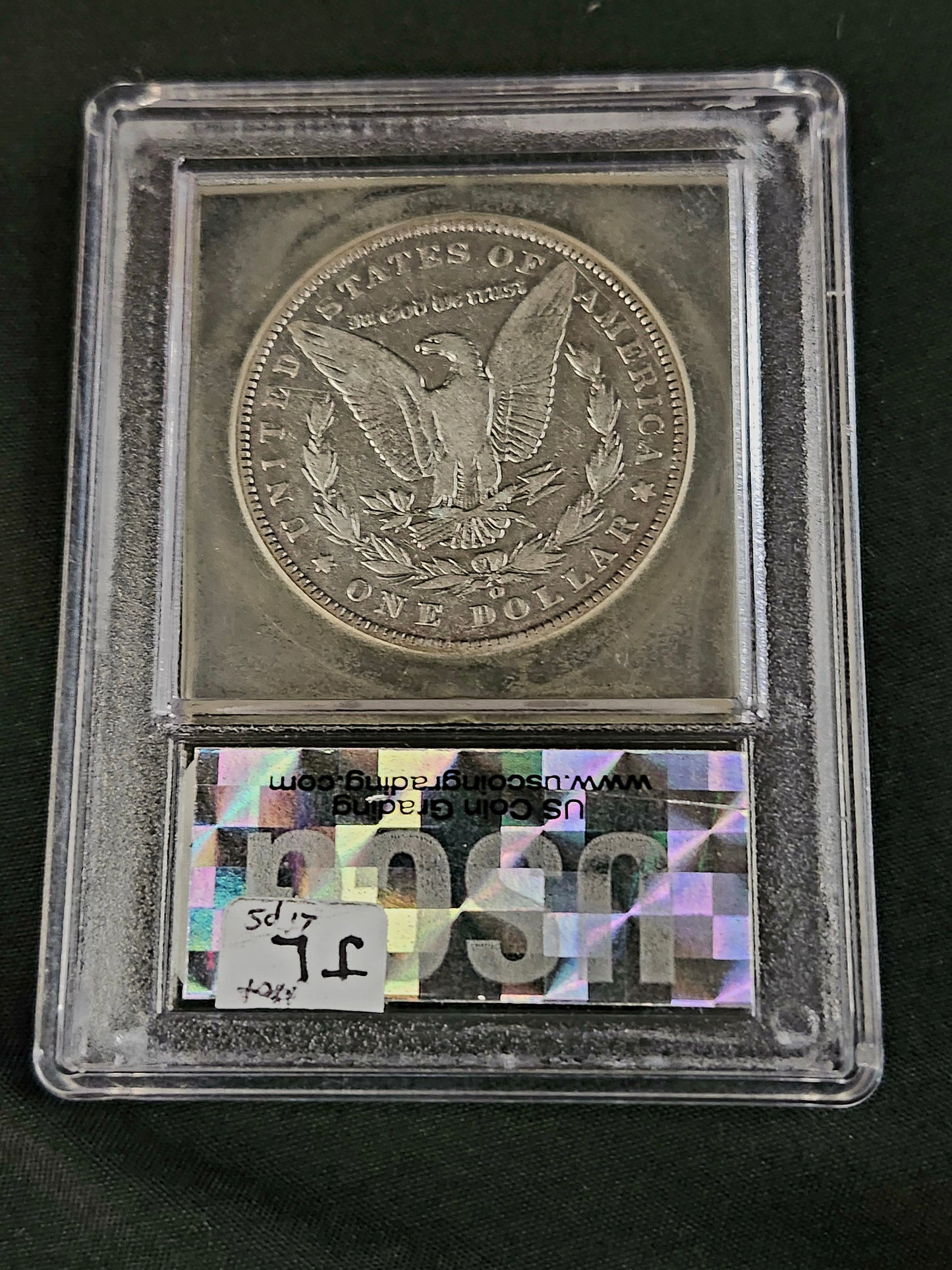 'Hot Lips' Morgan Silver Dollar coin in a USCG certified protective case with mint mark 'O' on a black background