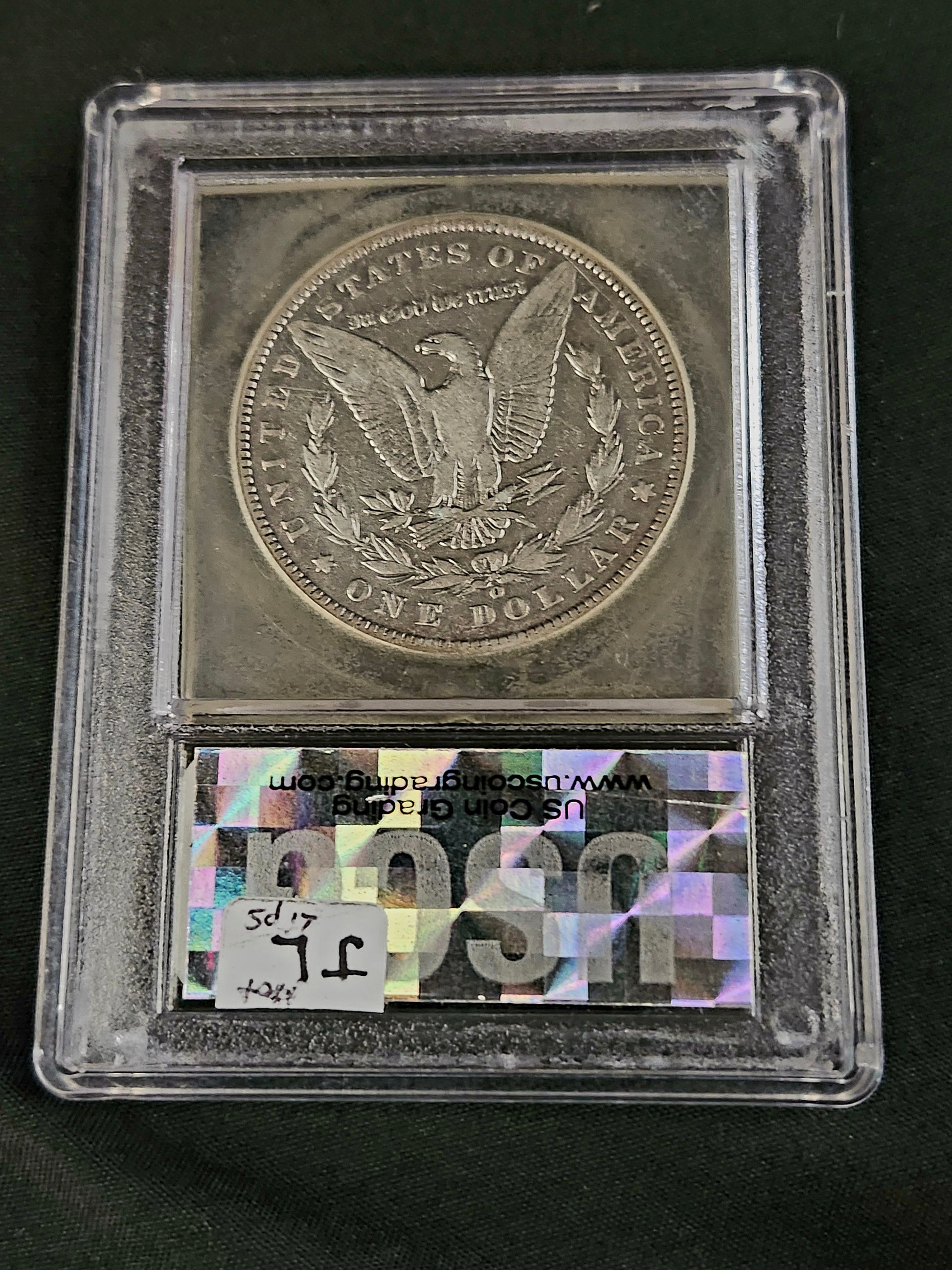 'Hot Lips' Morgan Silver Dollar coin in a USCG certified protective case with mint mark 'O' on a black background