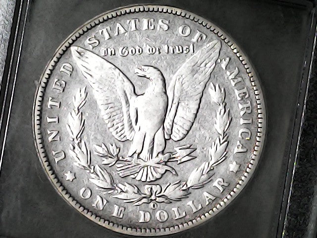 Silver dollar coin with an eagle emblem and 'O' inscription on a dark background