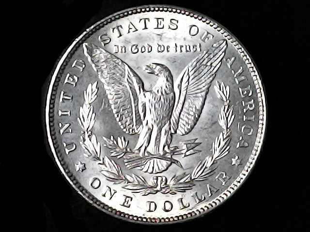 Silver Dollar with an eagle design and 'In God We Trust' inscription on a black background