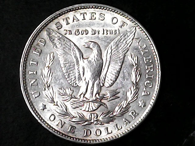 Silver Dollar with an eagle design and 'In God We Trust' inscription on a black background
