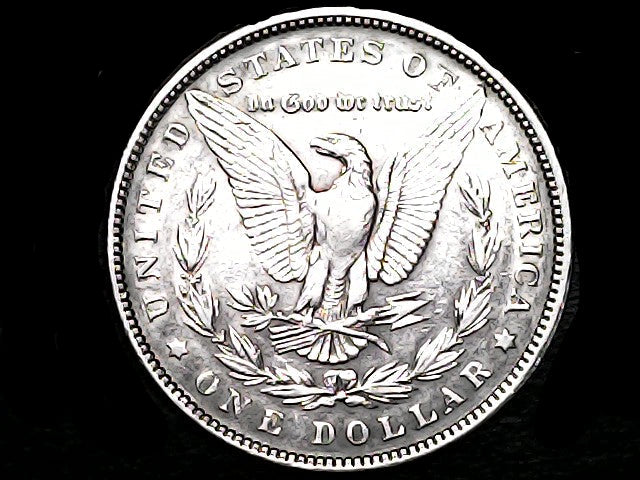 Silver Dollar with an eagle design and 'In God We Trust' inscription on a black background