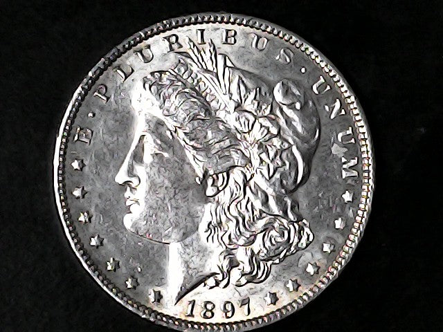 Silver Morgan Dollar Left-facing profile of Liberty wearing a Phrygian cap, with 'LIBERTY', "E PLURIBUS UNUM" and '1897' inscriptions on a black background with case