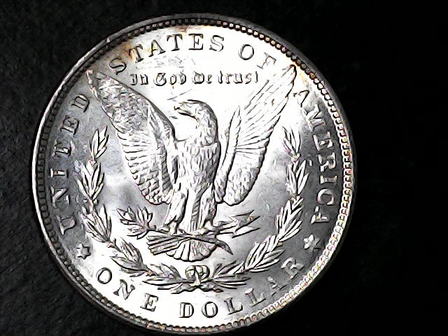 Silver Dollar coin with an eagle design on a black background