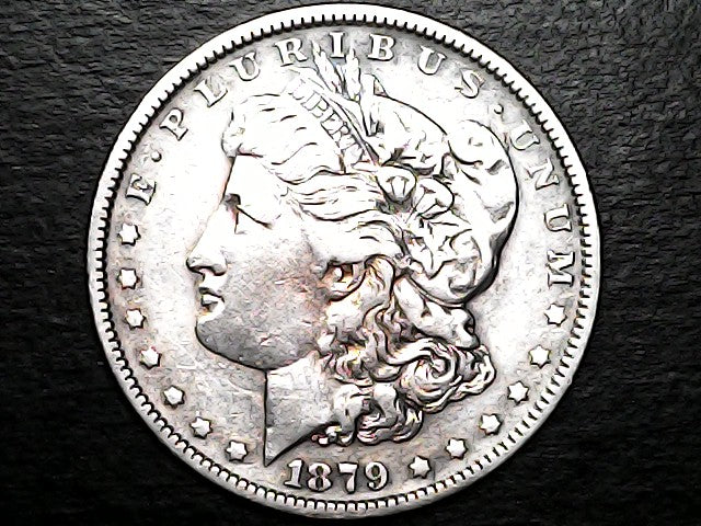 Silver Morgan Dollar Left-facing profile of Liberty wearing a Phrygian cap, with 'LIBERTY', "E PLURIBUS UNUM" and '1879' inscriptions on a black background with caseSilver Dollar with an eagle design, 'In God We Trust' and with "S" inscription on a black background