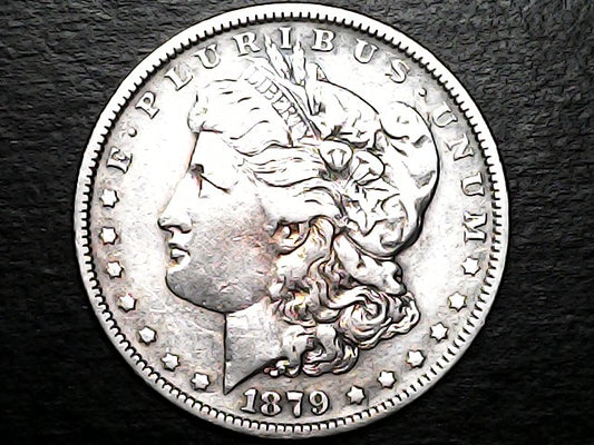 Silver Morgan Dollar Left-facing profile of Liberty wearing a Phrygian cap, with 'LIBERTY', "E PLURIBUS UNUM" and '1879' inscriptions on a black background with caseSilver Dollar with an eagle design, 'In God We Trust' and with "S" inscription on a black background