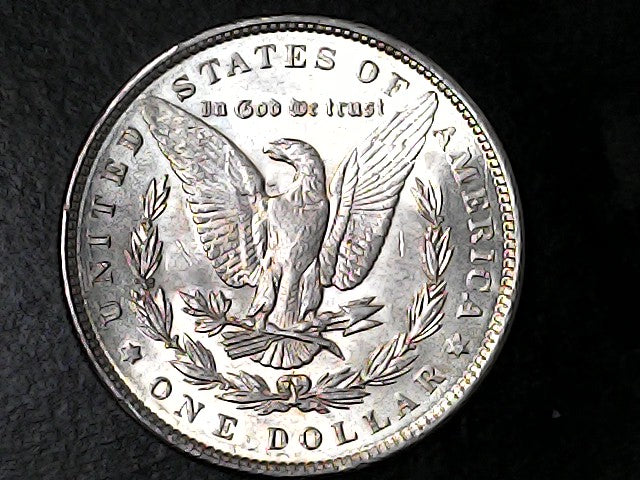 Silver Dollar with an eagle design and 'In God We Trust' inscription on a black background