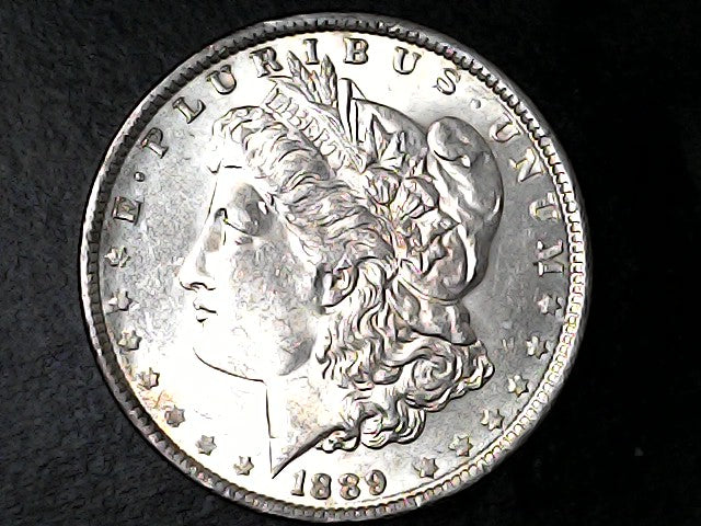 Silver Morgan Dollar Left-facing profile of Liberty wearing a Phrygian cap, with 'LIBERTY', "E PLURIBUS UNUM" and '1889' inscriptions on a black background with case
