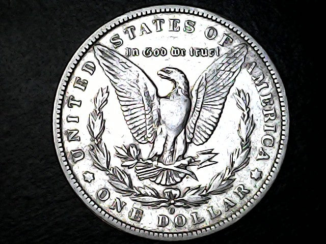 Silver Dollar with an eagle design, 'In God We Trust' and 'O' inscriptions on a black background 