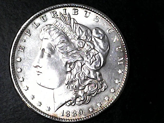 Silver Morgan Dollar with 'E Pluribus Unum', 'Liberty'  and '1889' inscriptions on a black background