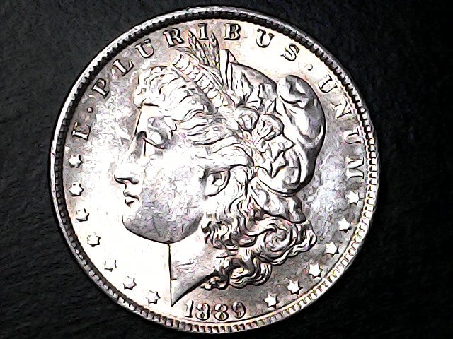Silver Morgan Dollar with 'E Pluribus Unum', 'Liberty'  and '1888' inscriptions on a black background