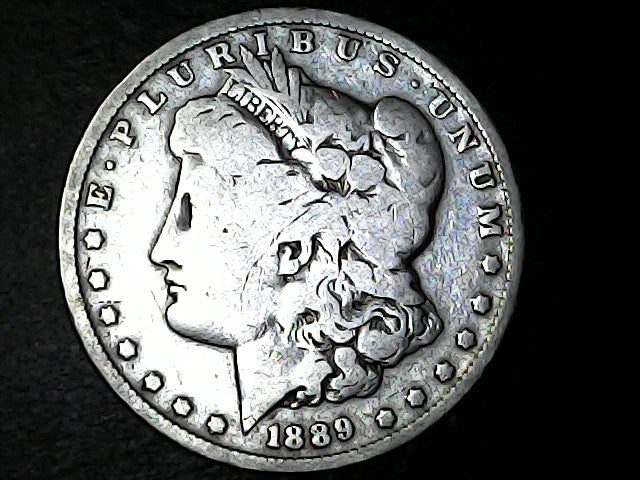 Silver Morgan Dollar with 'E Pluribus Unum', 'Liberty'  and '1889' inscriptions on a black background