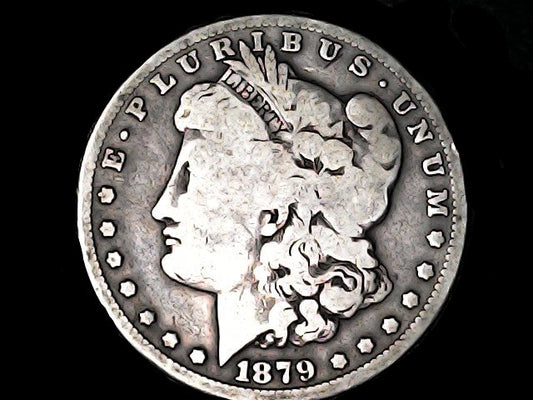 Silver Morgan dollar coin with 'E Pluribus Unum' and '1879' inscription on a dark background