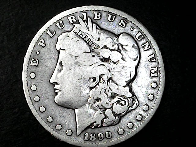 Silver Morgan Dollar with 'E Pluribus Unum', 'Liberty'  and '1890' inscriptions on a black background with case