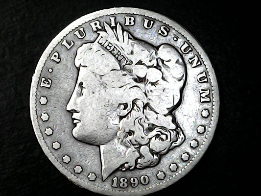 Silver Morgan Dollar with 'E Pluribus Unum', 'Liberty'  and '1890' inscriptions on a black background with case