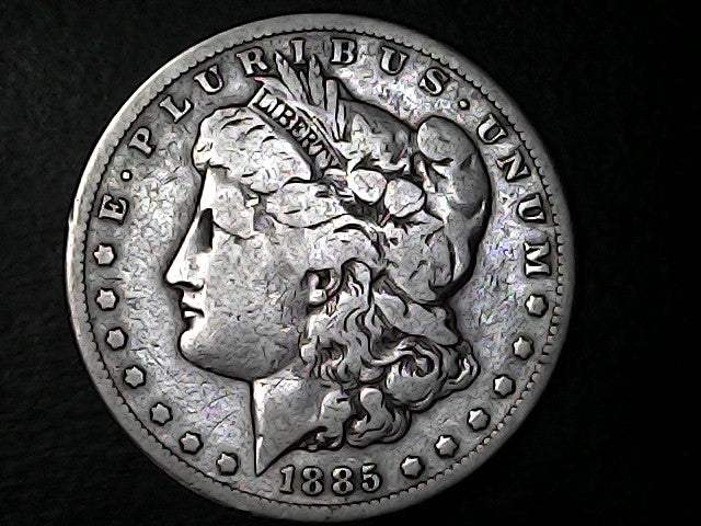 Silver Morgan Dollar with 'E Pluribus Unum' and '1885' inscriptions on a dark background