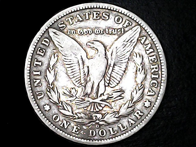 Silver dollar coin with an eagle design and 'O' inscription on a dark background