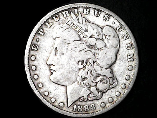 Silver Morgan dollar coin with 'E Pluribus Unum', 'Liberty' and '1888' inscriptions on a dark background