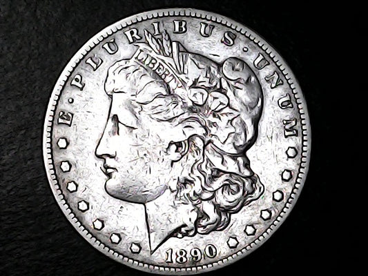 Silver Morgan Dollar with 'E Pluribus Unum', 'Liberty'  and '1890' inscriptions on a black background