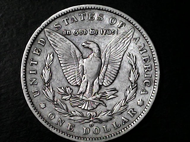 Silver Dollar with an eagle design, 'In God We Trust' and 'O' inscriptions on a black background 