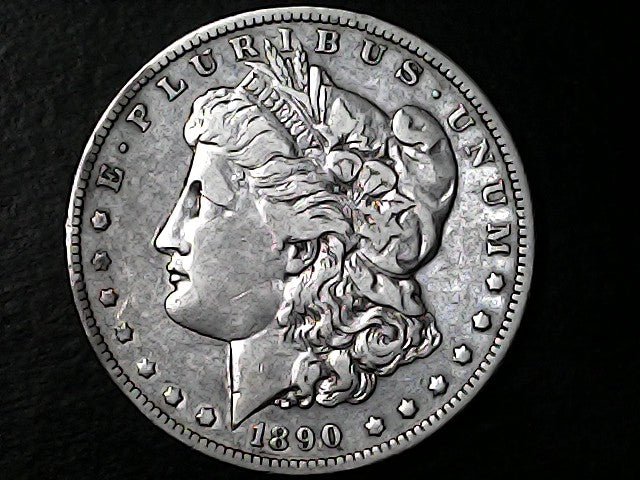 Silver Morgan Dollar Left-facing profile of Liberty wearing a Phrygian cap, with 'LIBERTY', "E PLURIBUS UNUM" and '1890' inscriptions on a black background with case