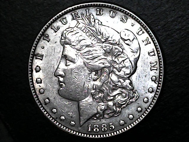 Silver Morgan dollar coin with 'E Pluribus Unum' and '1885' on a dark background  "Back Coin"