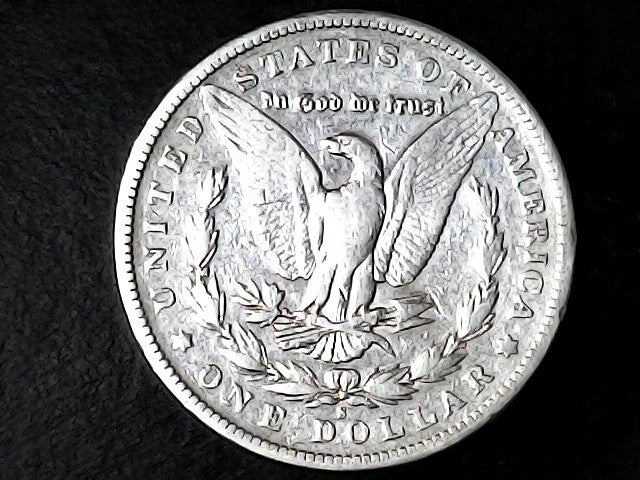 Silver Dollar with an eagle design, 'In God We Trust' and 'S' inscriptions on a black background 