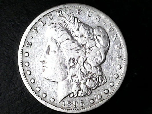 Silver Morgan Dollar Left-facing profile of Liberty wearing a Phrygian cap, with 'LIBERTY', "E PLURIBUS UNUM" and '1896' inscriptions on a black background with case