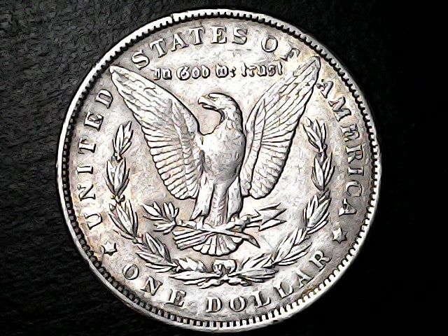 Silver Dollar with an eagle design on a black background 