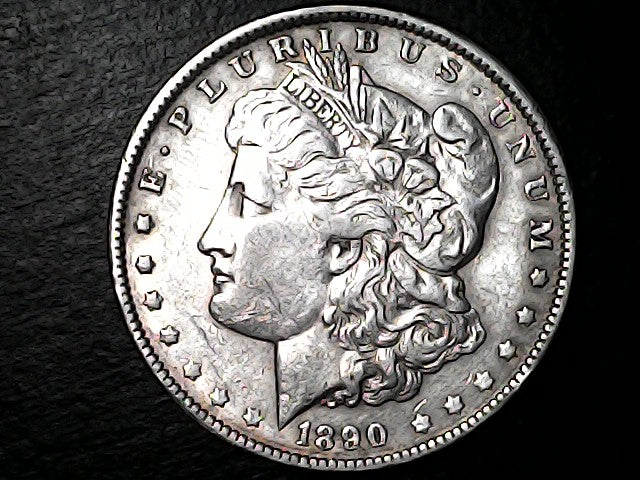Silver Morgan Dollar with 'E Pluribus Unum', 'Liberty'  and '1890' inscriptions on a black background with case