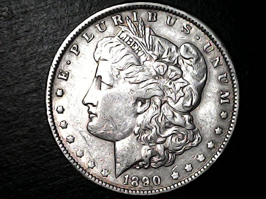 Silver Morgan Dollar with 'E Pluribus Unum', 'Liberty'  and '1890' inscriptions on a black background with case