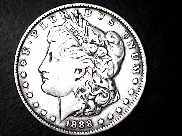 Silver Morgan dollar coin with 'E Pluribus Unum', 'Liberty'  and '1888' inscriptions on a black background