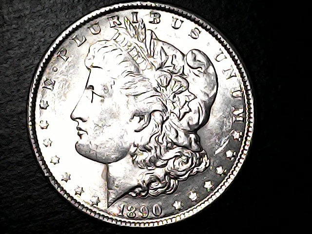 Silver Morgan Dollar with 'E Pluribus Unum', 'Liberty'  and '1890' inscriptions on a black background with case