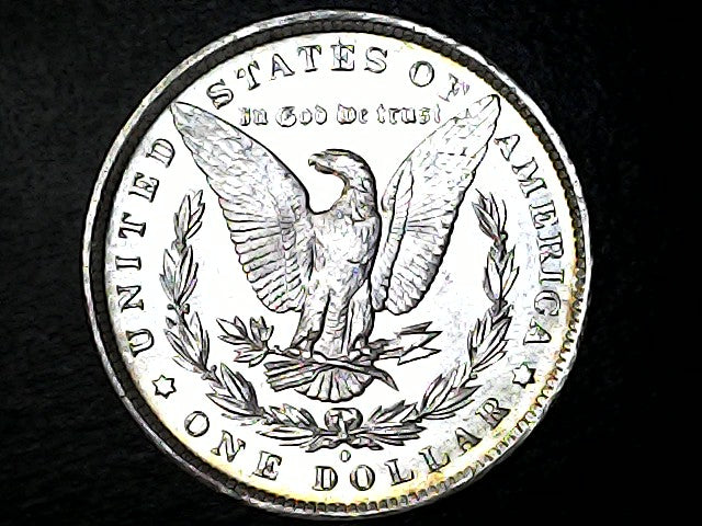 Silver dollar coin with an eagle design on a black background
