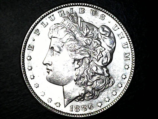 Silver Morgan Dollar coin with 'Liberty' head and 'E Pluribus Unum' inscription on a dark background
