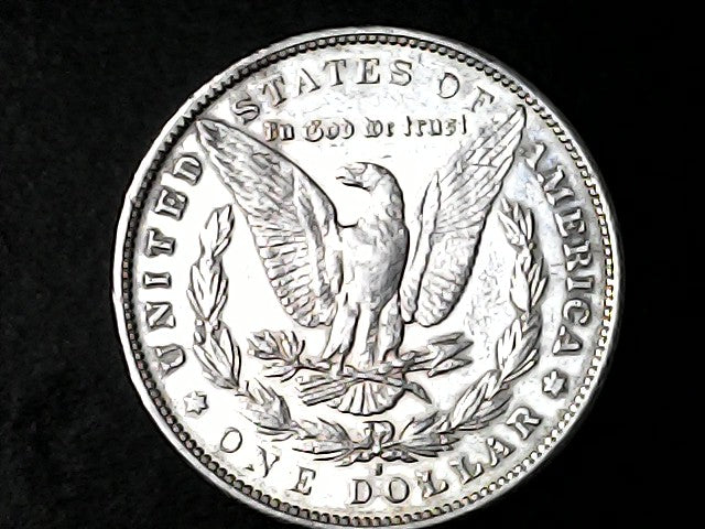 Silver Dollar with an eagle design, 'In God We Trust' and 'S' inscriptions on a black background 
