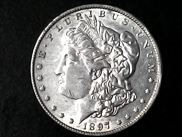 Silver Morgan Dollar Left-facing profile of Liberty wearing a Phrygian cap, with 'LIBERTY', "E PLURIBUS UNUM" and '1897' inscriptions on a black background with case