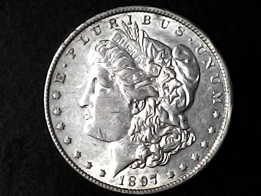 Silver Morgan Dollar Left-facing profile of Liberty wearing a Phrygian cap, with 'LIBERTY', "E PLURIBUS UNUM" and '1897' inscriptions on a black background with case